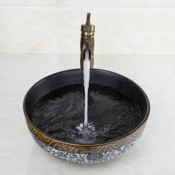 Nostalgische bronskleurige afgewerkte wastafel kraan met hand geschilderde keramiek waskom